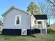 Back exterior featuring a gray siding, black trim and a small deck at 1210 Shaw St, Burlington, NC 27217