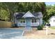 Charming single-story home with light gray siding, a welcoming front porch, and a well-maintained yard at 1210 Shaw St, Burlington, NC 27217