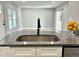 Open floor plan showcases a kitchen island with a stainless steel sink and modern faucet at 1210 Shaw St, Burlington, NC 27217