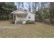 Charming single-story home with a white exterior, small porch, and well-established landscaping at 1219 Carlton Ave, Raleigh, NC 27606