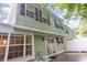 View of the backyard with light green siding and dark shutters at 1325 Legacy Greene Ave, Wake Forest, NC 27587