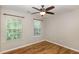 Bright bedroom with two windows, wood-look floors, and a ceiling fan at 1325 Legacy Greene Ave, Wake Forest, NC 27587