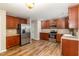 Spacious kitchen featuring stainless steel appliances, ample wood cabinets, and wood-look vinyl floors at 1325 Legacy Greene Ave, Wake Forest, NC 27587