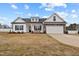 Charming two-story home showcasing stone accents, a two-car garage, and manicured landscaping at 137 Rolling Pasture Way, Sanford, NC 27332