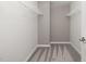 Empty walk-in closet with shelves and carpeting at 1401 Hollyview Ave, Durham, NC 27703