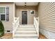 Close-up view of a front entrance featuring a dark door with glass and concrete steps at 1716 Ferrell Meadows Dr, Zebulon, NC 27597