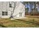 Backyard view featuring a concrete patio, sliding glass doors, and surrounded by mature trees at 172 Great Gln, Rocky Mount, NC 27804