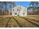 Spacious backyard featuring a concrete patio, sliding glass doors, and surrounded by mature trees at 172 Great Gln, Rocky Mount, NC 27804