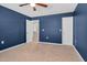 Bedroom with blue walls, carpet, ceiling fan and access to bathroom and closet at 172 Great Gln, Rocky Mount, NC 27804