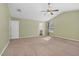 Neutral carpeted bedroom with en suite access, soft green walls, and ceiling fan at 172 Great Gln, Rocky Mount, NC 27804