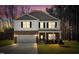 Exterior view of a charming two-story home at dusk, featuring stone accents and a well-lit front yard at 172 Great Gln, Rocky Mount, NC 27804