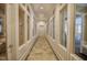 Bright hallway featuring herringbone floors, white striped walls, and multiple glass-paneled rooms at 172 Great Gln, Rocky Mount, NC 27804