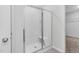 Bathroom shower featuring a modern glass door, seating, and bright white tile at 172 Great Gln, Rocky Mount, NC 27804