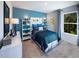 Bright bedroom featuring a large bed, fun decor, and plenty of natural light from the window at 1780 Pie Filling Dr, Haw River, NC 27258