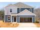Charming two-story home featuring a spacious two-car garage and classic blue siding at 1780 Pie Filling Dr, Haw River, NC 27258