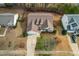 An aerial view of a home showing the roof, yard, driveway, garage, and landscaping at 1906 Holly Knoll Ln, Fuquay Varina, NC 27526