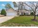 Charming one-story home with a manicured lawn and an attached two-car garage at 1906 Holly Knoll Ln, Fuquay Varina, NC 27526