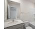 Well-lit bathroom with a large mirror, vanity, sink, and shower-tub combo at 204 Starlight St, Sanford, NC 27330