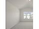 Vaulted-ceiling bedroom with plush carpet and neighborhood views through a large window at 204 Starlight St, Sanford, NC 27330