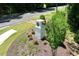 Landscaped community entrance with brick signage and manicured green space at 204 Starlight St, Sanford, NC 27330