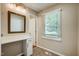 Bright bathroom features a vanity with mirror and natural light from window at 207 Wyatts Pond Ln, Cary, NC 27513