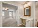 Bathroom vanity with mirror next to bedroom with natural light coming through windows at 207 Wyatts Pond Ln, Cary, NC 27513
