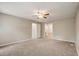 Neutral bedroom showcasing door to bath, ceiling fan, and closet at 207 Wyatts Pond Ln, Cary, NC 27513