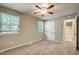 Neutral bedroom showcasing windows, ceiling fan and entry to the bathroom at 207 Wyatts Pond Ln, Cary, NC 27513