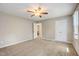 Spacious bedroom with neutral carpet, ceiling fan, and a bright window at 207 Wyatts Pond Ln, Cary, NC 27513