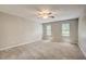 Inviting bedroom features neutral walls, carpet, and a ceiling fan at 207 Wyatts Pond Ln, Cary, NC 27513