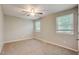 Well-lit bedroom featuring neutral walls and carpet, plus ample natural light at 207 Wyatts Pond Ln, Cary, NC 27513