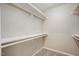 Bright walk-in closet has neutral-colored walls with ample storage space at 207 Wyatts Pond Ln, Cary, NC 27513