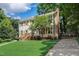 Charming two-story home features lush green lawn, mature trees, and brick chimney at 207 Wyatts Pond Ln, Cary, NC 27513