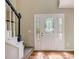 Bright entryway featuring hardwood floors, a staircase, and a glass-paneled front door at 207 Wyatts Pond Ln, Cary, NC 27513