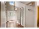 Bright foyer featuring hardwood floors, a staircase, and a glass-paneled front door at 207 Wyatts Pond Ln, Cary, NC 27513