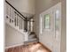 Light-filled foyer with hardwood floors, staircase, and front door with decorative glass at 207 Wyatts Pond Ln, Cary, NC 27513