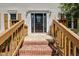 Inviting front door with decorative glass and brick steps leading to a porch at 207 Wyatts Pond Ln, Cary, NC 27513