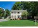 Traditional home with a well-manicured lawn and mature trees provides curb appeal at 207 Wyatts Pond Ln, Cary, NC 27513