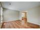 Inviting living room with hardwood floors and an open doorway to another room at 207 Wyatts Pond Ln, Cary, NC 27513