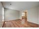 Inviting living room with hardwood floors and an open doorway to another room at 207 Wyatts Pond Ln, Cary, NC 27513