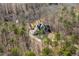 A stunning aerial view showcases the home nestled in a private, wooded area at 209 Democracy Pl, Apex, NC 27523