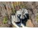 An aerial view of a house with a distinctive roofline, surrounded by trees, and a circular driveway entrance at 209 Democracy Pl, Apex, NC 27523