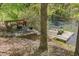 Backyard with deck seating and a wooden dock, overlooking the waterway at 209 Democracy Pl, Apex, NC 27523