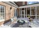 Backyard patio with ample space for relaxation, complemented by brick architecture and comfortable seating arrangements at 209 Democracy Pl, Apex, NC 27523