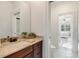 Bathroom with granite vanity and open doorway to a bedroom at 209 Democracy Pl, Apex, NC 27523