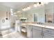Elegant bathroom featuring double vanities, granite countertops, and a glass-enclosed walk-in shower at 209 Democracy Pl, Apex, NC 27523