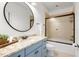 Charming bathroom with blue vanity, granite countertop, and glass-enclosed shower at 209 Democracy Pl, Apex, NC 27523