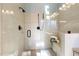 Luxurious walk-in shower with neutral tile, glass enclosure, and bronze hardware fixtures at 209 Democracy Pl, Apex, NC 27523