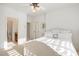 Bedroom features neutral color palette, plush bedding, and an en suite bathroom at 209 Democracy Pl, Apex, NC 27523