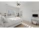 Bright bedroom with white decor, plantation shutters, ceiling fan, and carpet flooring at 209 Democracy Pl, Apex, NC 27523